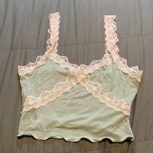 A green tank top with lace straps and lace around the chest!